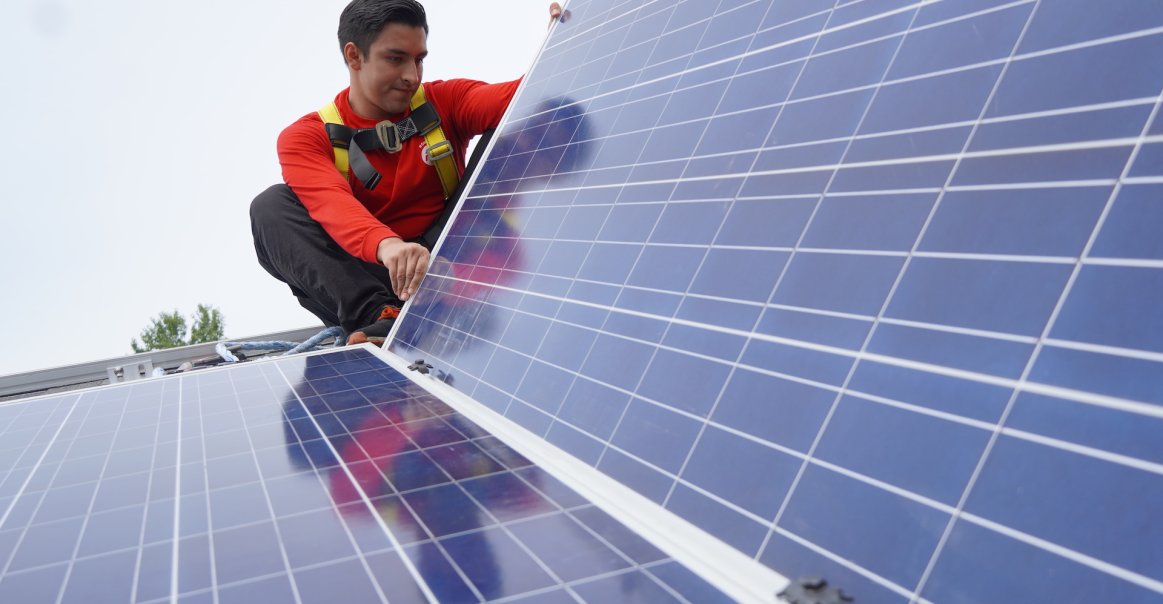 Volunteer with Solar Panel Volunteer with Solar Panel