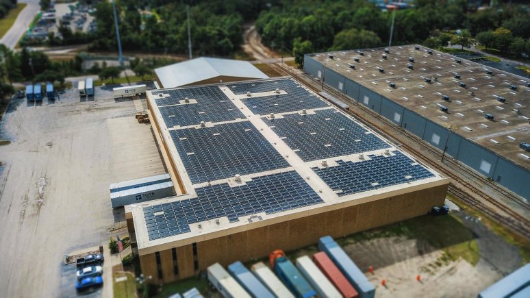 Solar panel installation on a warehouse, rooftop view