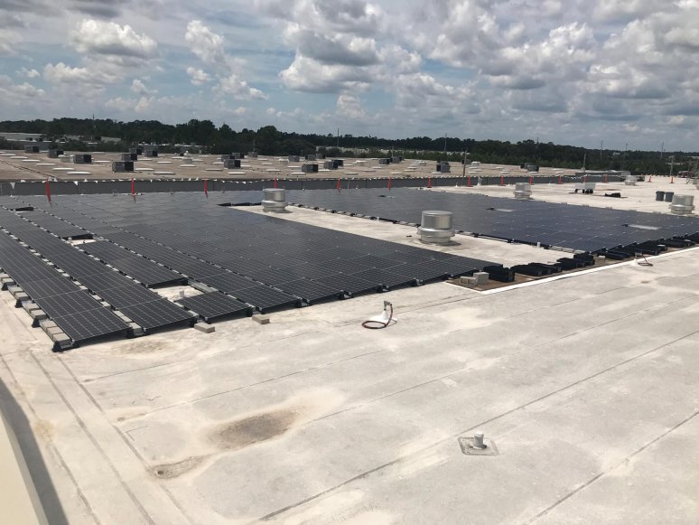 Solar panel installation on a warehouse, rooftop view
