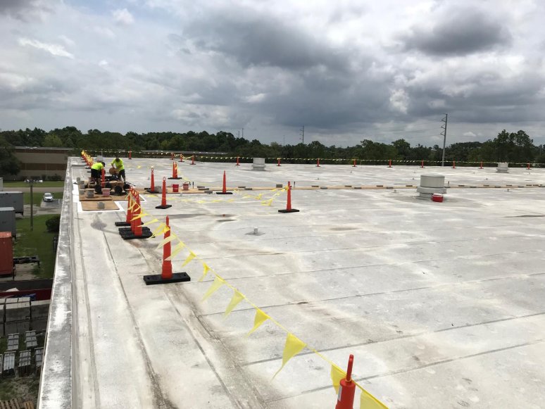 Solar panel installation on a warehouse, rooftop view